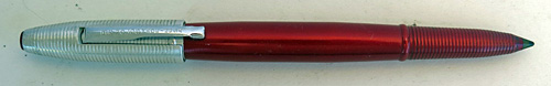 4582: REYNOLDS INTERNATIONAL BALLPOINT IN ANODIZED DARK RED WITH ALUMINUM CAP WITH CIRCUMFERENTIAL GROVES. CAP COVER HAS MATCHING RED TIP. CAP REMOVES AND SNAPS ON OVER THE FRONT END OF THE PEN. COMES WITH PAPER INSTRUCTIONS AND GUARENTEE. CONTAINS A CLEAR, STRONG, STRAIT CELLOPHANE COVER AND AN ALUMINUM PEDISTOOL. ALL ITEMS FIT INSIDE AND ELABORATE CYLINDRICAL DISPLAY CASE IN OLIVE GREEN WITH REYNOLDS PEN LOGO STILL VISABLE