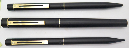 ITEM #4805: SET OF THREE. SHEAFFER OVERSIZE TARGA IN BLACK LACQUOR ON METAL. GOLD ELECTROPLATED TRIM. FOUNTAIN PEN HAS 14K NIB IN MEDIUM. SHEAFFER SQUEEZE FILLING UNIT. PENCIL IS TWIST ACTUATED. BALLPOINT ASLO TWIST ACTUATED