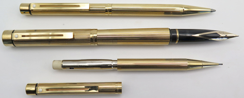 ITEM #4809: SET OF 3 SHEAFFER STANDARD SIZE TARGA IN GOLD ELECTROPLATED VERTICAL LINE PATTERN. GOLD ELECTROPLATED TRIM. FOUNTAIN PEN HAS 14K STUB BROAD NIB. WIDTH OF NIB IS 0.052". SHEAFFER SQUEEZE FILLER.