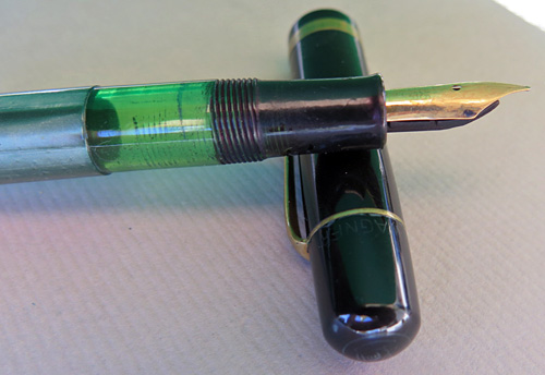 5408: PELIKAN 100 N WITH VERY FLEXIBLE MEDIUM NIB IN 14K GOLD. BLACK CAP WITH GREEN STRIPED BINDE WITH GOLD FILLED TRIM