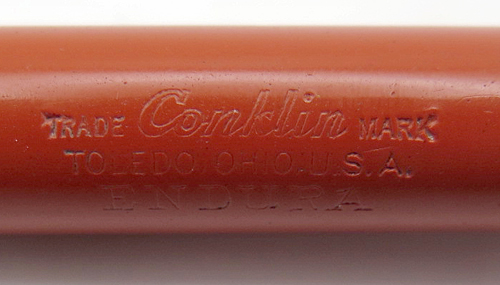 ITEM #6459: CONKLIN ORANGE ENDURA TOLEDO FOUNTAIN PEN. SPRING CLIP AND GOLD FILL TRIM. NIB IS "CONKLIN #4 TOLEDO" IN BROAD