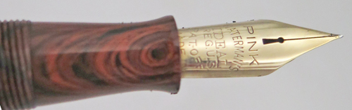 ITEM #6774: WATERMAN FOUNTAIN PEN #7 IN RED RIPPLE. "PINK" COLOR CODED NIB WHICH INDICATES A FLEX NIB. KEYHOLE BREATHER HOLE IN MEDIUM NIB. LEVER FILLER. CLEAR IMPRINT. 