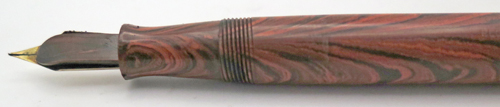 ITEM #6774: WATERMAN FOUNTAIN PEN #7 IN RED RIPPLE. "PINK" COLOR CODED NIB WHICH INDICATES A FLEX NIB. KEYHOLE BREATHER HOLE IN MEDIUM NIB. LEVER FILLER. CLEAR IMPRINT. 