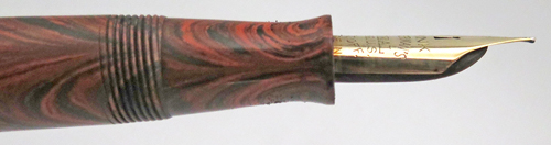 ITEM #6774: WATERMAN FOUNTAIN PEN #7 IN RED RIPPLE. "PINK" COLOR CODED NIB WHICH INDICATES A FLEX NIB. KEYHOLE BREATHER HOLE IN MEDIUM NIB. LEVER FILLER. CLEAR IMPRINT. 