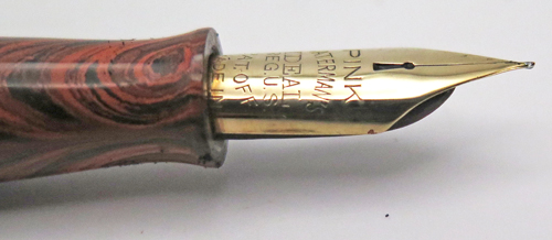ITEM #6774: WATERMAN FOUNTAIN PEN #7 IN RED RIPPLE. "PINK" COLOR CODED NIB WHICH INDICATES A FLEX NIB. KEYHOLE BREATHER HOLE IN MEDIUM NIB. LEVER FILLER. CLEAR IMPRINT. 